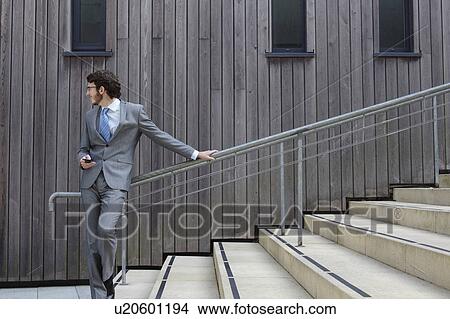 Picture - Businessman waiting on steps. Fotosearch