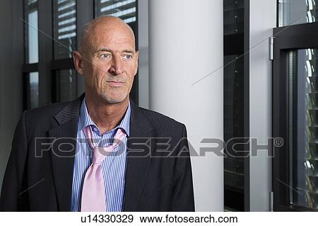 Stock Photo - Businessman with loose tie in office. Fotosearch