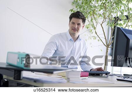 Picture - Businessman working at desk. Fotosearch