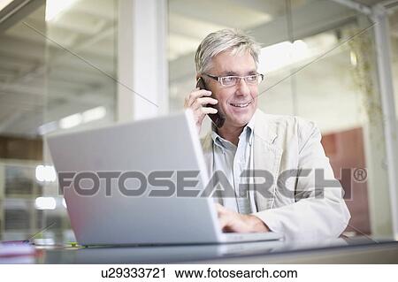 Businessman working in office View Large Photo Image Stock Image - Businessman working in office. Fotosearch