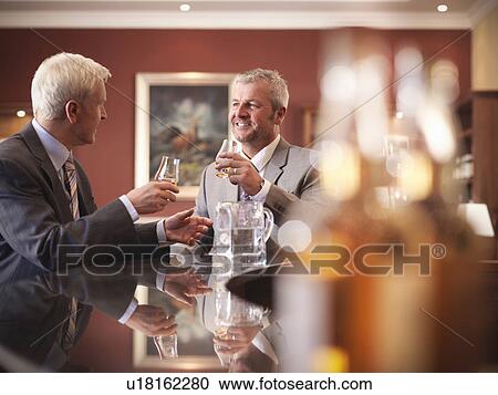 Businessmen drinking together in bar View Large Photo Image Stock Image - Businessmen drinking together in bar. Fotosearch