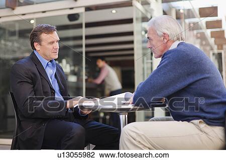 Businessmen meeting in cafe View Large Photo Image Stock Image - Businessmen meeting in cafe. Fotosearch