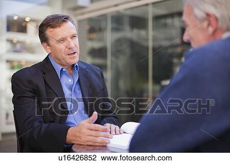 Businessmen meeting in cafe View Large Photo Image Stock Image - Businessmen meeting in cafe. Fotosearch