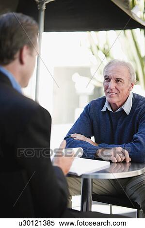 Businessmen meeting in cafe View Large Photo Image Stock Photography - Businessmen meeting in cafe. Fotosearch