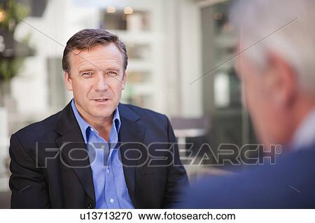 Businessmen meeting with colleague View Large Photo Image Stock Image - Businessmen meeting with colleague. Fotosearch
