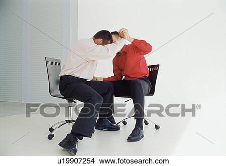 Businessmen playing in office chairs View Large Photo Image Picture - Businessmen playing in office chairs. Fotosearch