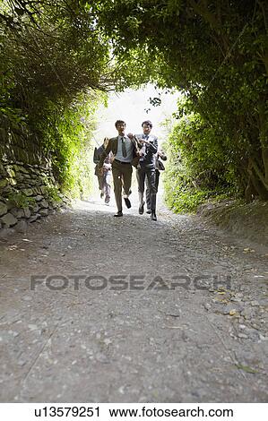 Businessmen racing on rural road View Large Photo Image Stock Image - Businessmen racing on rural road. Fotosearch