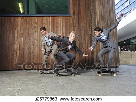 Businessmen riding skateboards View Large Photo Image Stock Image - Businessmen riding skateboards. Fotosearch