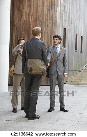 Businessmen shaking hands in courtyard View Large Photo Image Stock Image - Businessmen shaking hands in courtyard. Fotosearch