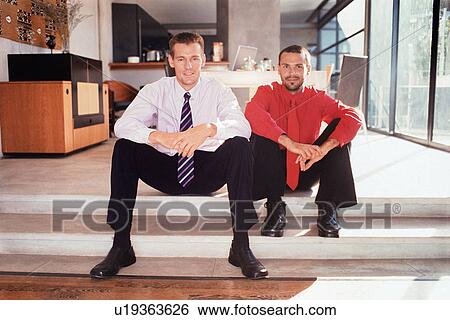 Businessmen sitting on steps together View Large Photo Image Stock Photograph - Businessmen sitting on steps together. Fotosearch
