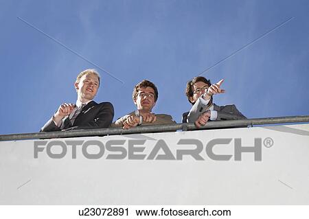 Businessmen standing on walkway View Large Photo Image Stock Image - Businessmen standing on walkway. Fotosearch