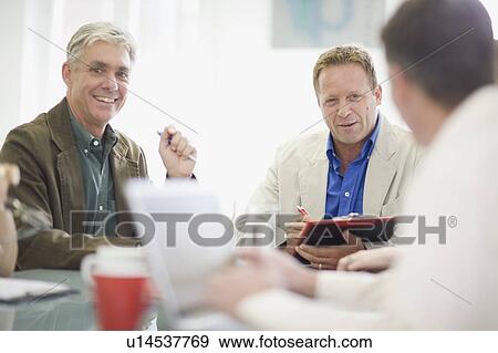 Stock Photo - Businessmen talking in meeting. Fotosearch