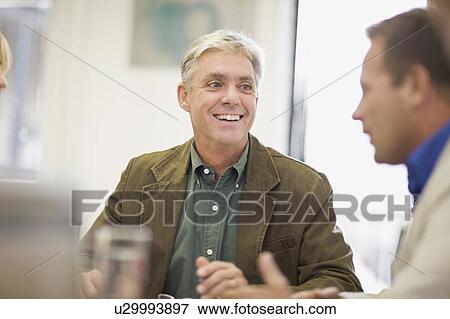 Stock Photo - Businessmen talking in meeting. Fotosearch