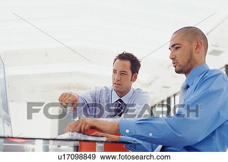 Businessmen working on computer View Large Photo Image Stock Photo - Businessmen working on computer. Fotosearch