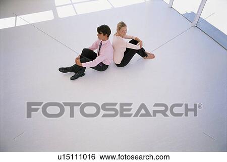 Businesspeople sitting back-to-back View Large Photo Image Stock Photograph - Businesspeople sitting back-to-back. Fotosearch