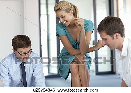 Businesspeople talking in office View Large Photo Image Stock Photograph - Businesspeople talking in office. Fotosearch