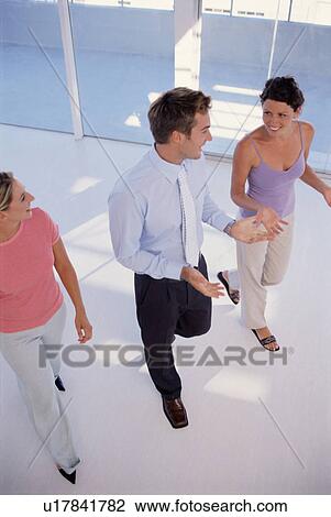 Stock Image - Businesspeople walking together. Fotosearch