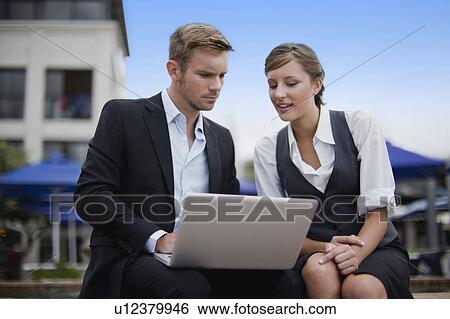 Businesspeople working by fountain View Large Photo Image Stock Photograph - Businesspeople working by fountain. Fotosearch