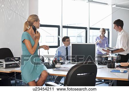 Stock Image - Businesspeople working in office. Fotosearch
