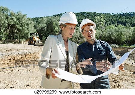 Stock Photo - Businesswoman and foreman on site. Fotosearch