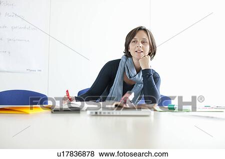 Businesswoman at empty conference desk View Large Photo Image Stock Photo - Businesswoman at empty conference desk. Fotosearch