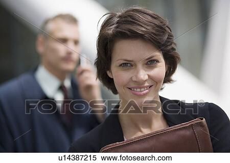 Stock Photography - Businesswoman carrying leather folder. Fotosearch