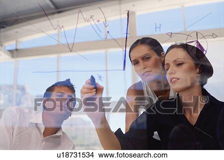 Businesswoman drawing graph on glass View Large Photo Image Picture - Businesswoman drawing graph on glass. Fotosearch