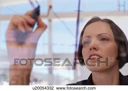 Businesswoman drawing graph on glass View Large Photo Image Stock Image - Businesswoman drawing graph on glass. Fotosearch