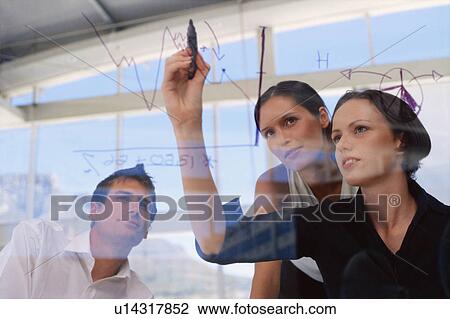 Businesswoman drawing graphs on glass View Large Photo Image Stock Image - Businesswoman drawing graphs on glass. Fotosearch