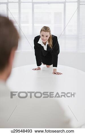 Businesswoman flirting with colleague View Large Photo Image Stock Image - Businesswoman flirting with colleague. Fotosearch