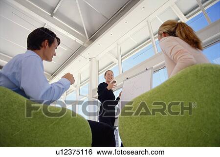 Stock Photograph - Businesswoman giving presentation. Fotosearch