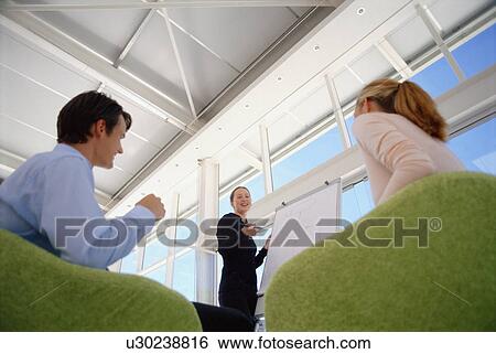 Stock Photograph - Businesswoman giving presentation. Fotosearch