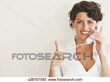 Stock Image - Businesswoman giving ‘thumbs up’. Fotosearch