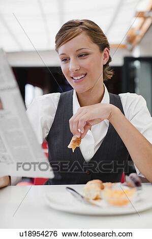 Businesswoman having breakfast View Large Photo Image Stock Photograph - Businesswoman having breakfast. Fotosearch