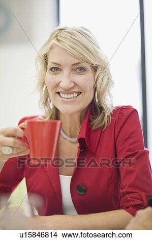 Picture - Businesswoman having cup of coffee. Fotosearch