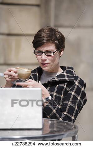 Businesswoman having cup of coffee View Large Photo Image Picture - Businesswoman having cup of coffee. Fotosearch