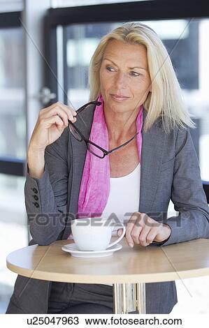Businesswoman having cup of coffee View Large Photo Image Stock Image - Businesswoman having cup of coffee. Fotosearch