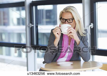 Businesswoman having cup of coffee View Large Photo Image Stock Photograph - Businesswoman having cup of coffee. Fotosearch