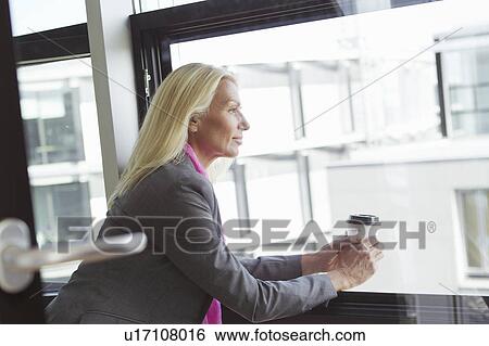 Stock Photograph - Businesswoman having cup of coffee. Fotosearch