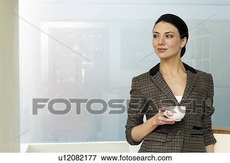 Businesswoman holding coffee cup View Large Photo Image Stock Photo - Businesswoman holding coffee cup. Fotosearch