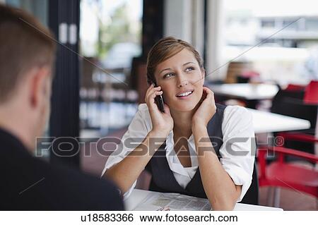 Businesswoman on cell phone at lunch View Large Photo Image Stock Photograph - Businesswoman on cell phone at lunch. Fotosearch