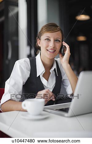 Businesswoman on cell phone with laptop View Large Photo Image Stock Image - Businesswoman on cell phone with laptop. Fotosearch