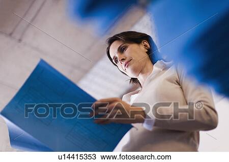 Businesswoman reading documents View Large Photo Image Stock Image - Businesswoman reading documents. Fotosearch