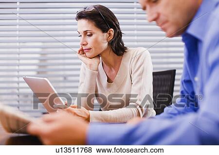 Businesswoman reading on tablet View Large Photo Image Stock Photo - Businesswoman reading on tablet. Fotosearch