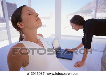 Businesswoman relaxing in office View Large Photo Image Stock Photo - Businesswoman relaxing in office. Fotosearch