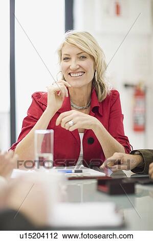 Businesswoman sitting in meeting View Large Photo Image Stock Image - Businesswoman sitting in meeting. Fotosearch