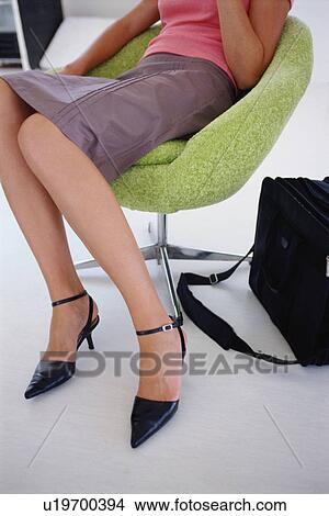Businesswoman sitting in modern chair View Large Photo Image Picture - Businesswoman sitting in modern chair. Fotosearch