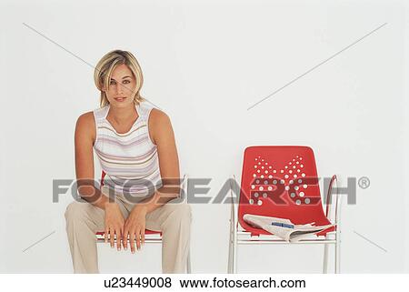 Stock Photo - Businesswoman sitting in modern chair. Fotosearch