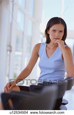 Businesswoman sitting in office chair View Large Photo Image Picture - Businesswoman sitting in office chair. Fotosearch