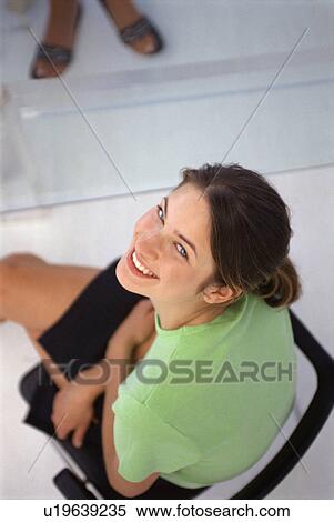 Businesswoman sitting in office chair View Large Photo Image Stock Photography - Businesswoman sitting in office chair. Fotosearch